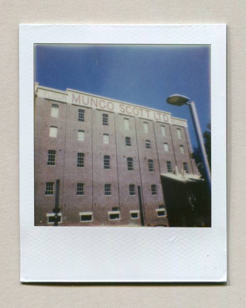<strong>Mungo Scott Facade</strong><br> <!-- title -->
September 2024<br> <!-- date -->
Scanned instant photo<br> <!-- medium -->
Polaroid Go Film<br> <!-- film stock -->
Polaroid Go Instant Camera<!-- camera/lens -->
<br><br>
<em> <!-- inspiration/motivation -->
The Mungo Scott building, part of the Summer Hill Flour Mill site. In the morning, the north-eastern facade (which has very little line-of-sight obstruction) is bathed in sunlight.
</em>
