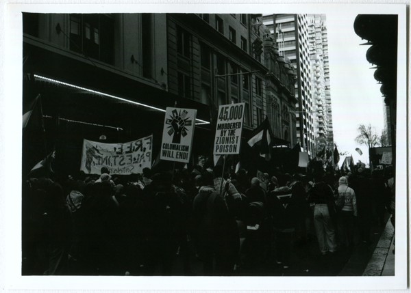 <strong>Free Palestine March</strong><br> <!-- title -->
July 2024<br> <!-- date -->
5x7" BW Enlargement<br> <!-- medium -->
Ilford FP4+ @ 125 ISO<br> <!-- film stock -->
Contax G1 + Zeiss Planar 35mm f/2 <!-- camera/lens -->
<br><br>
<em> <!-- inspiration/motivation -->
No description available yet.
</em>
